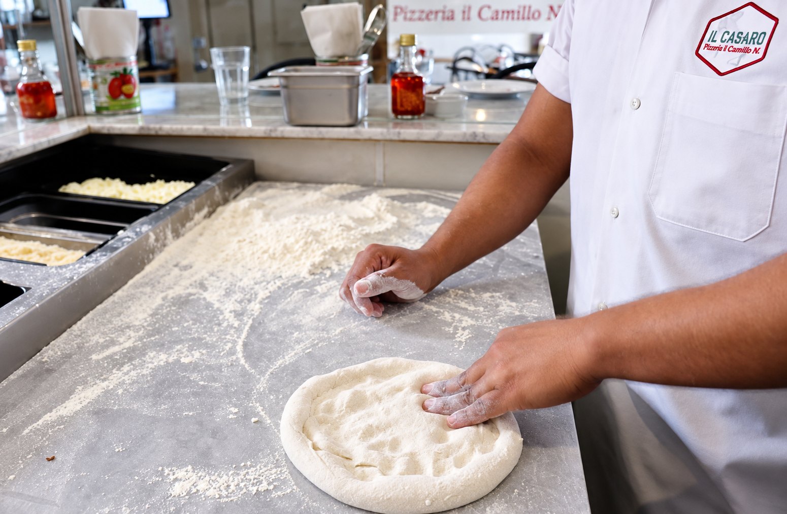 Il Casaro pizza maker stretching dough by hand