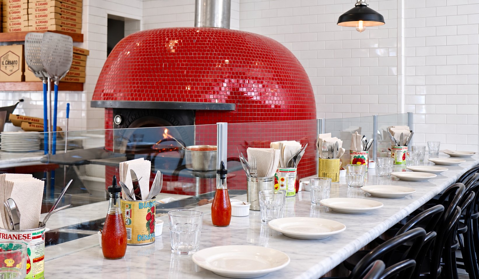 Il Casaro dining room with the red pizza oven